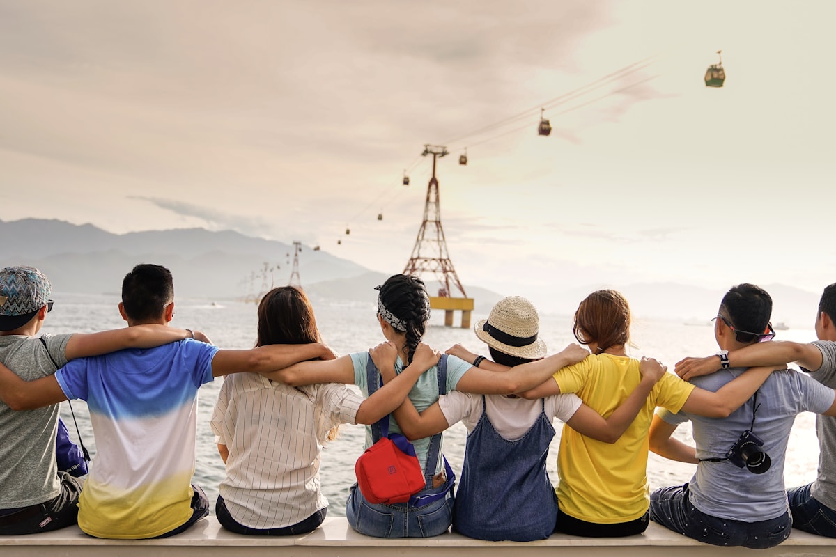 Group of neighbors sitting together with arms around each other
